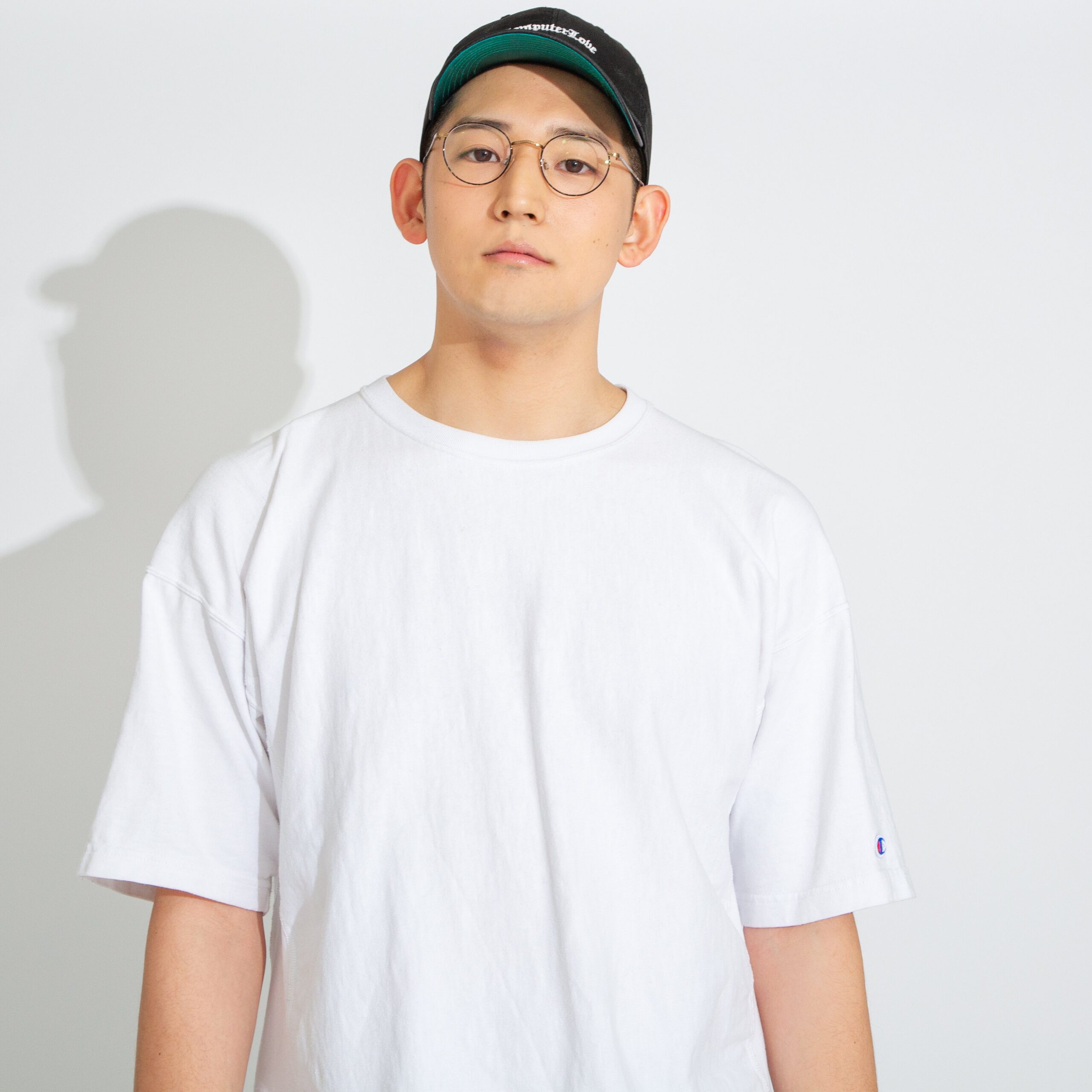 白いシャツと帽子をかぶる男性
