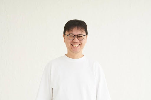 白い服を着た笑顔の男性