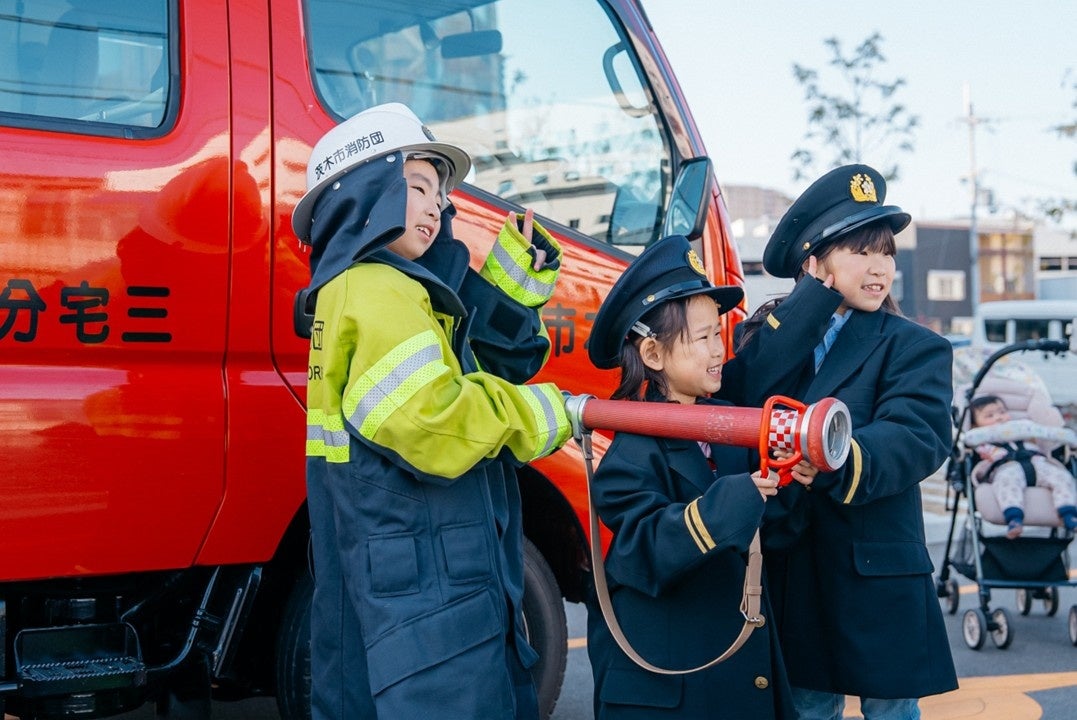 消防車の前で記念撮影する子どもたち